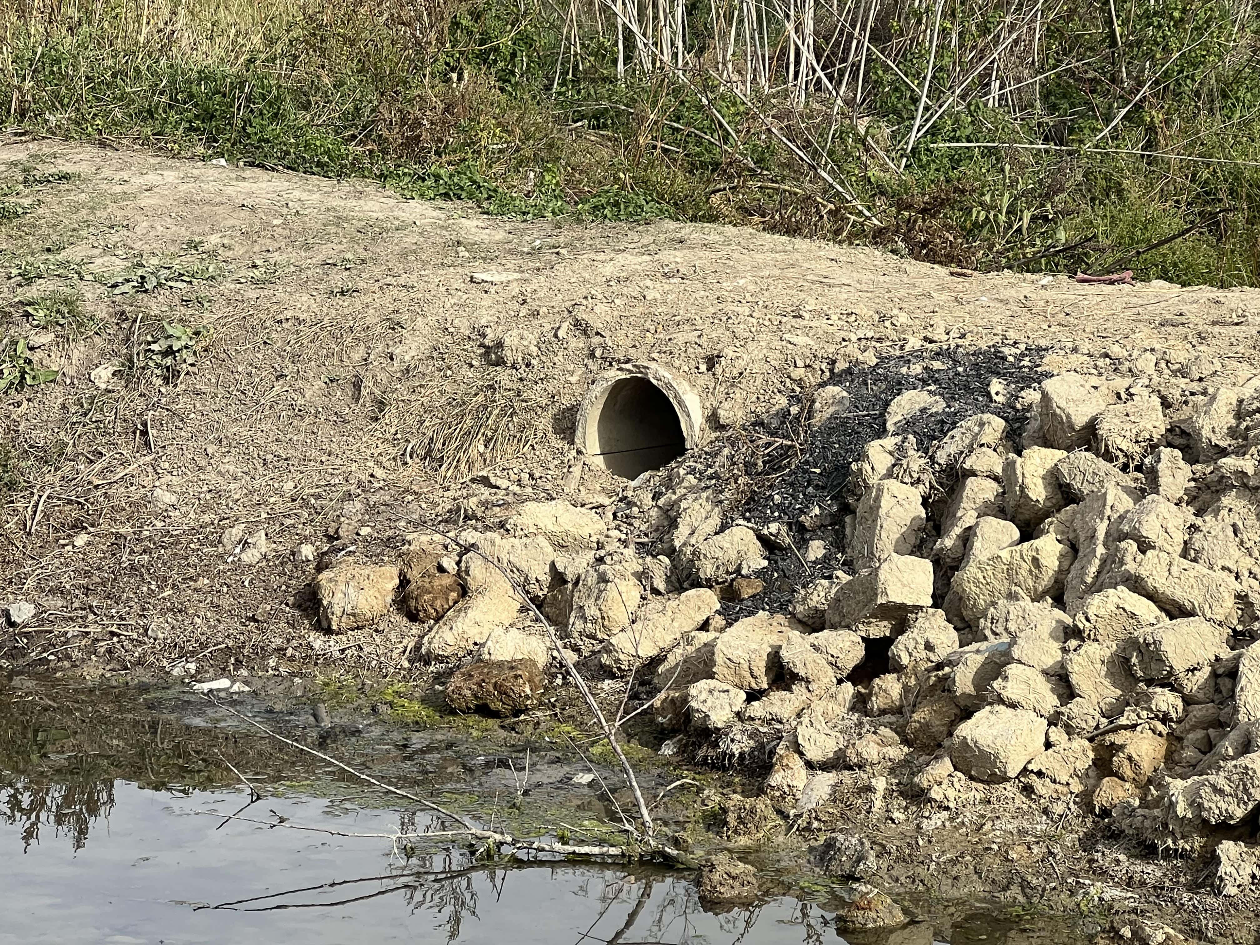 A dam on Ciulucul Mare at Bilicenii Vech. The dam across the stream was built using rubble. There is water on one side of the dam only. If the water level is too low, it will not reach the pipe in the centre at mid-height.  